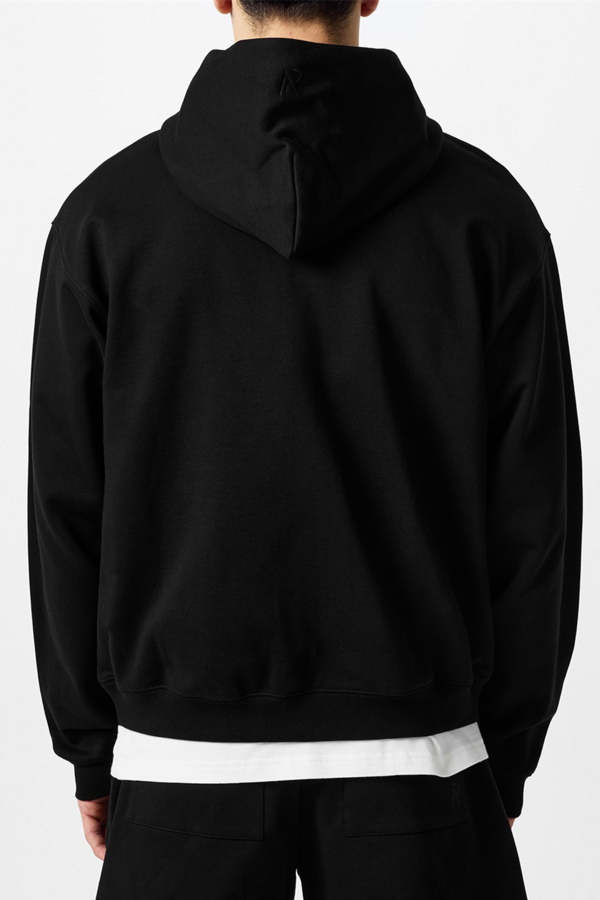 Back of a black hoodie.
